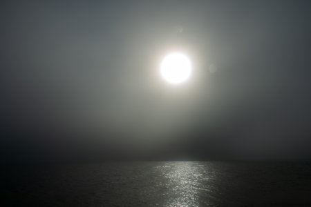 Fog over the sea and the morning sunrise, gloomy morning. Exfoliation, advection fog - cooling of...