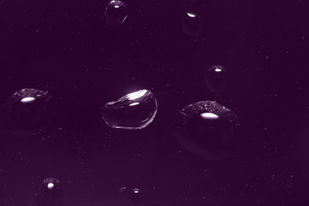 Waterdrops, water droplets on the window pane (view from the room). On a dark evening background. Ultra Macroの写真素材