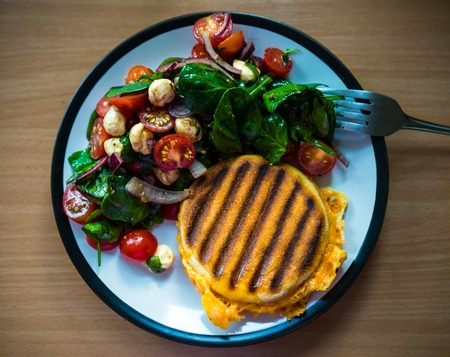 Homemade Breakfast grilled English miffin Sandwich served with side salad: cherry tomatoes, pearl...