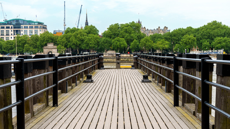 Wooden Pier at River Thames in Londonの写真素材