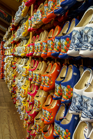Set of different colorful vintage Dutch wooden clogs on display