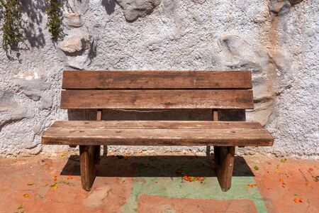 Old wooden bench on terracotta floor in tropical islandの写真素材
