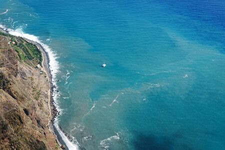 amazing view from the highest Cabo Girao cliff on the beach, ocean water and Camara de Lobos town, Madeira island, Portugal.の写真素材