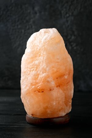 Himalayan pink salt lamp on dark backgroundの写真素材