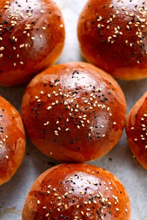 fresh homemade hamburger buns, baps on baking paper.の写真素材