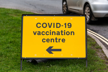 COVID-19 vaccination centre road sign on a streetの写真素材