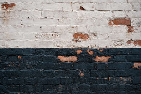 Grunge old white an black painted brick stone wall exterior Weathered textured pattern background with copy space for textの写真素材
