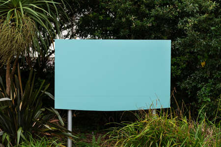 empty Billboard sign with copy space among green bushes and trees, greeneryの写真素材