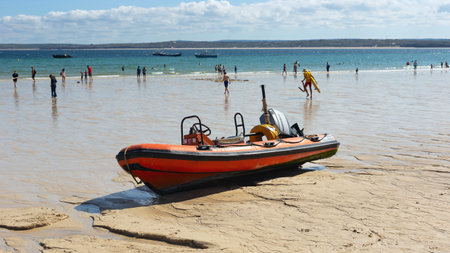 St Ives Harbour at low tide with boat waiting for high tide, Corwall, UK 27 August 2022の写真素材