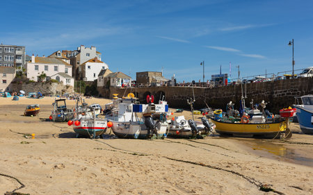 St Ives Harbour at low tide with fishing boats waiting for high tide, Corwall, UK 27 August 2022の写真素材