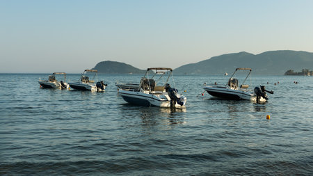 day trip motor boats anchored in bay of Zakynthos island, Greece, August 2023の写真素材