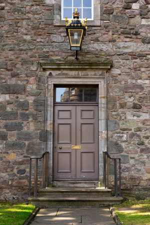 Old Georgian stone townhouse door with fanlight window above doorの写真素材