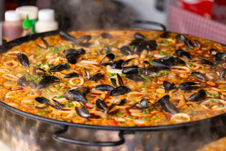 Seafood paella in a paella pan at a street food marketの写真素材
