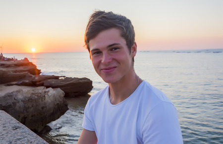 Handsome male model smiling after sunset