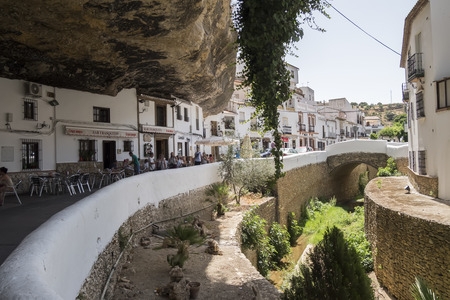 Setenil de las Bodegas, Cadiz, Spain. Street with dwellings built into rock overhangs above Rio Trejo.の写真素材