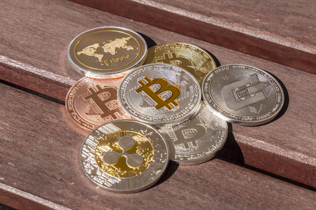Cryptocurrency coins over a wood table; Bitcoin, Ripple, Dashの写真素材