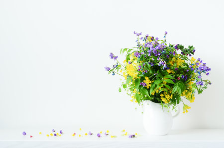 Bouquet of wildflowers in vase on white backgroundの写真素材