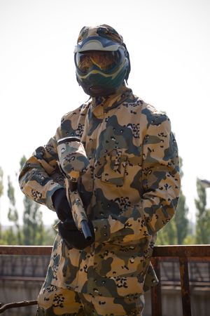 Paintball player in camouflage uniform の写真素材