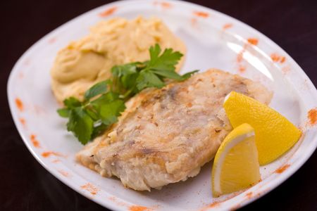 Fried fish and hummus with lemon, selective focus の写真素材