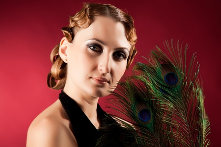 Portrait of elegant woman holding feather