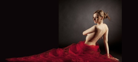 Nude body and rad long skirt, studio shotの写真素材