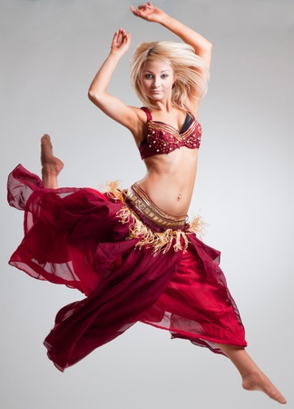 Posing in motion bellydancer, studio isolated shotの写真素材