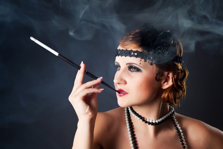 Smoking retro-styled sexy lady holding mouthpiece