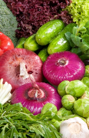 A close-up on vegetable, red onions, cucumbers, brussels cabbage, garlic, rucola salad, mint, broccoliの写真素材