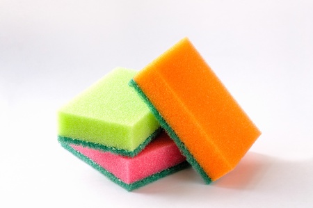 Three colored sponges on a white background