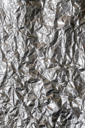 Crumpled aluminum metal foil with ambient reflectionの写真素材