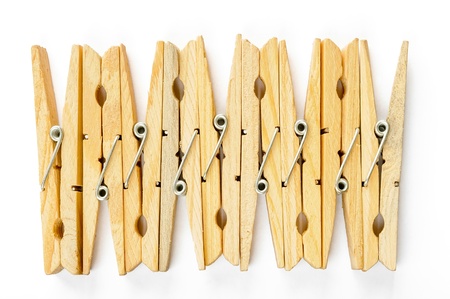 Nine wooden clothespins in row, on white backgroundの写真素材