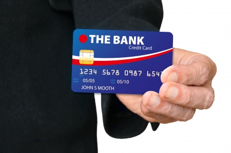 A man holding a credit card in his hand, and showing itの写真素材