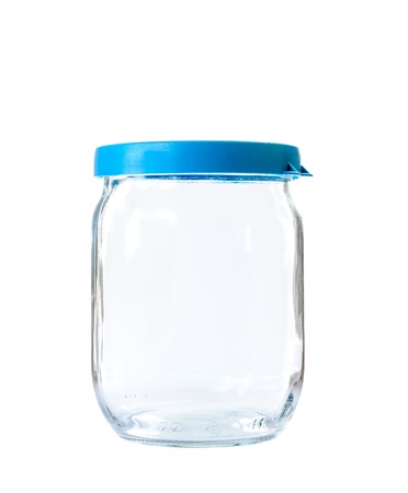 Transparent glass jar on white background, with the closed plastic blue topの写真素材