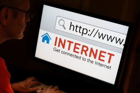 Man on keyboard getting connected on the Internetの写真素材