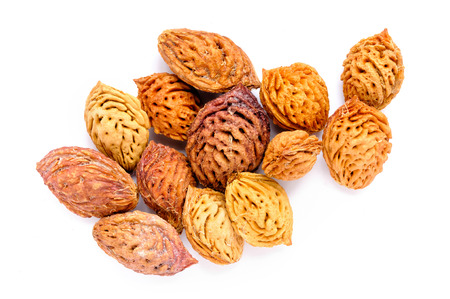 Yellow and red peach kernels isolated on a white background