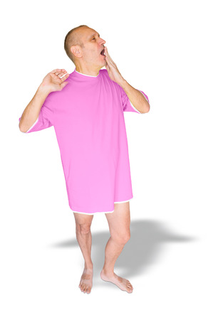 Man in pink nightdress, waking up and yawning, on white backgroundの写真素材
