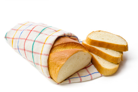 A piece of traditional white bread with three cut slicesの写真素材