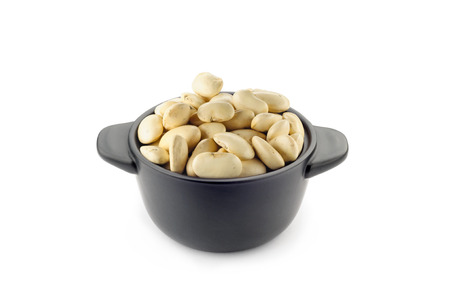 A little black ceramic dish with white cannellini beansの写真素材
