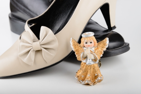 Male and female shoes with a sweet little angel for Saint Valentine Day, the day of the loversの写真素材