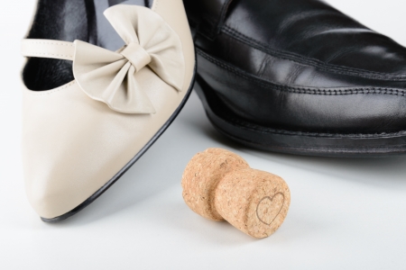 Male and female shoes with a Champagne cork, for Saint Valentine Day, the day of the lovers, or any holiday celebrationの写真素材