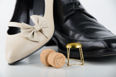 Male and female shoes with a Champagne cork, for Saint Valentine Day, the day of the lovers, or any holiday celebrationの写真素材