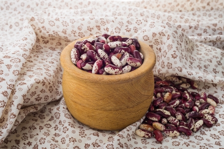 Red Cannellini beans in a wooden bowl on a flourish tableclothの写真素材