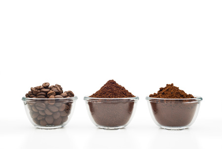 Coffee beans, ground coffee and instant coffee, in little glass cups on a clean white の写真素材