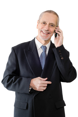 An amiable businessman smiling on mobile phoneの写真素材