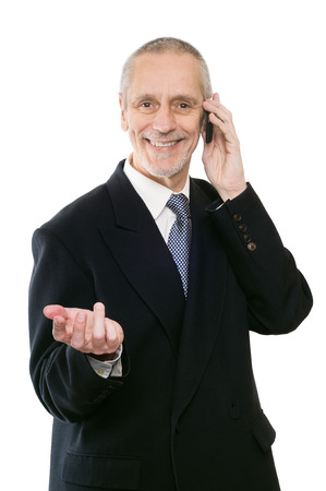 An agreeable businessman smiling on mobile phoneの写真素材
