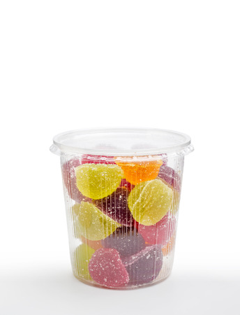 Colorful fruit jelly in foam jar, on white の写真素材