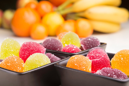 Colorful fruit jelly in little black ceramic cups. の写真素材