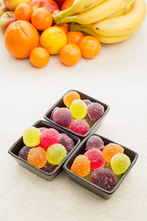 Colorful fruit jelly in little black ceramic cups. の写真素材