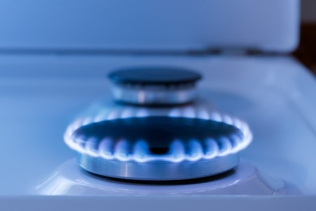 The blue flame from the burner of a gas stove