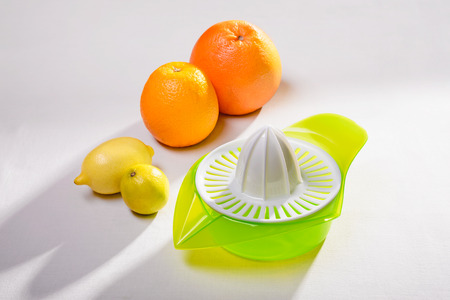 A citrus squeezer with lime, lemon, orange and grapefruitの写真素材